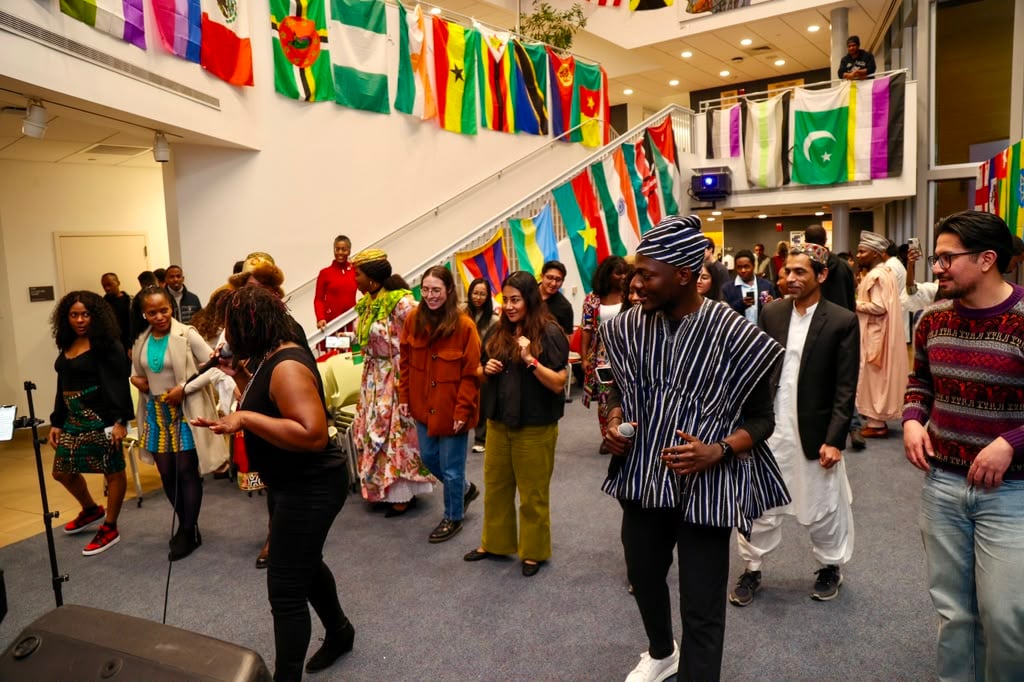 Students from many countries gathered beneath rows of national flags at a campus international festival